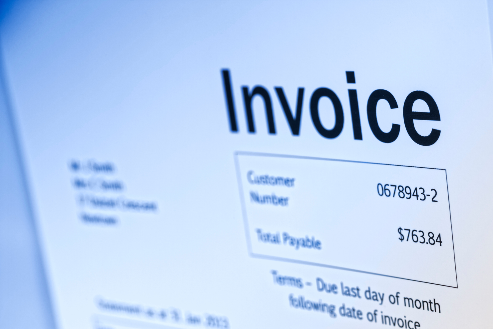 Close-up of a printed medical invoice showing a customer number and total payable amount.