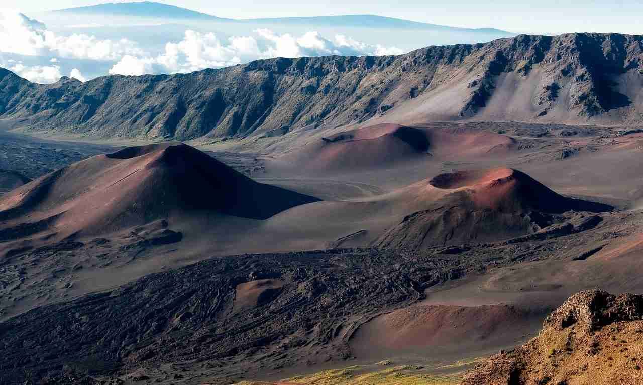 Volcanic cinder cones inside Haleakala Crater on Maui beneath morning clouds.