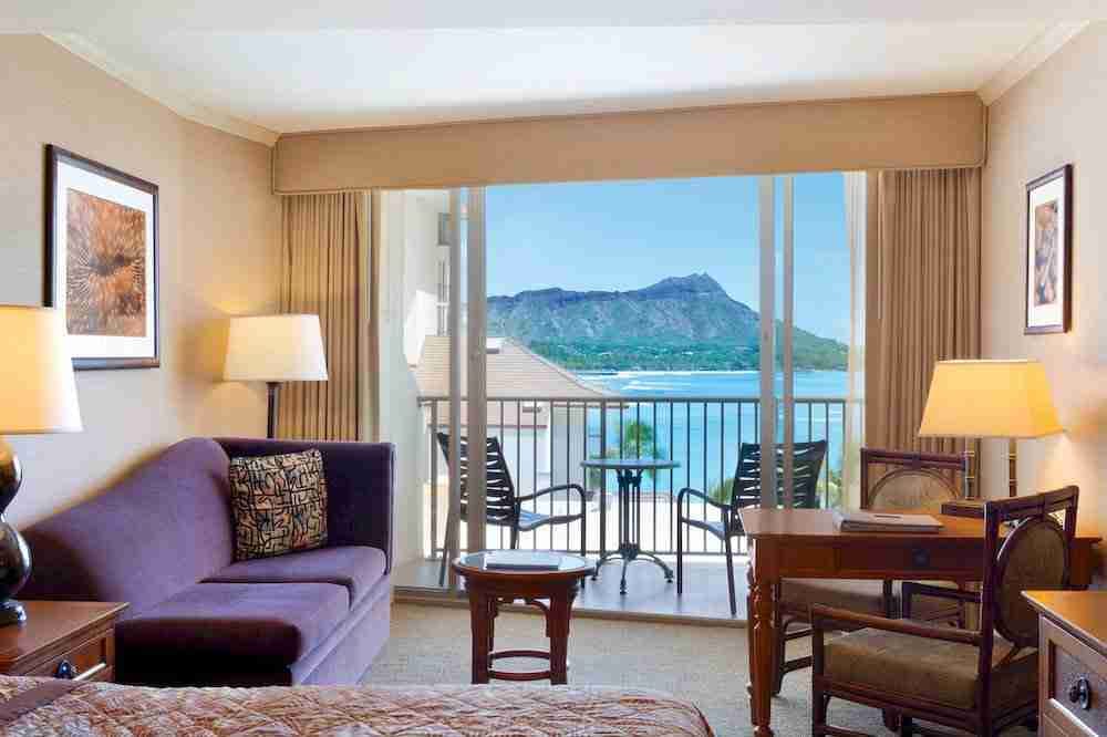 Hotel room with lanai views of Diamond Head and the ocean at the Outrigger Reef Waikiki Beach Resort.