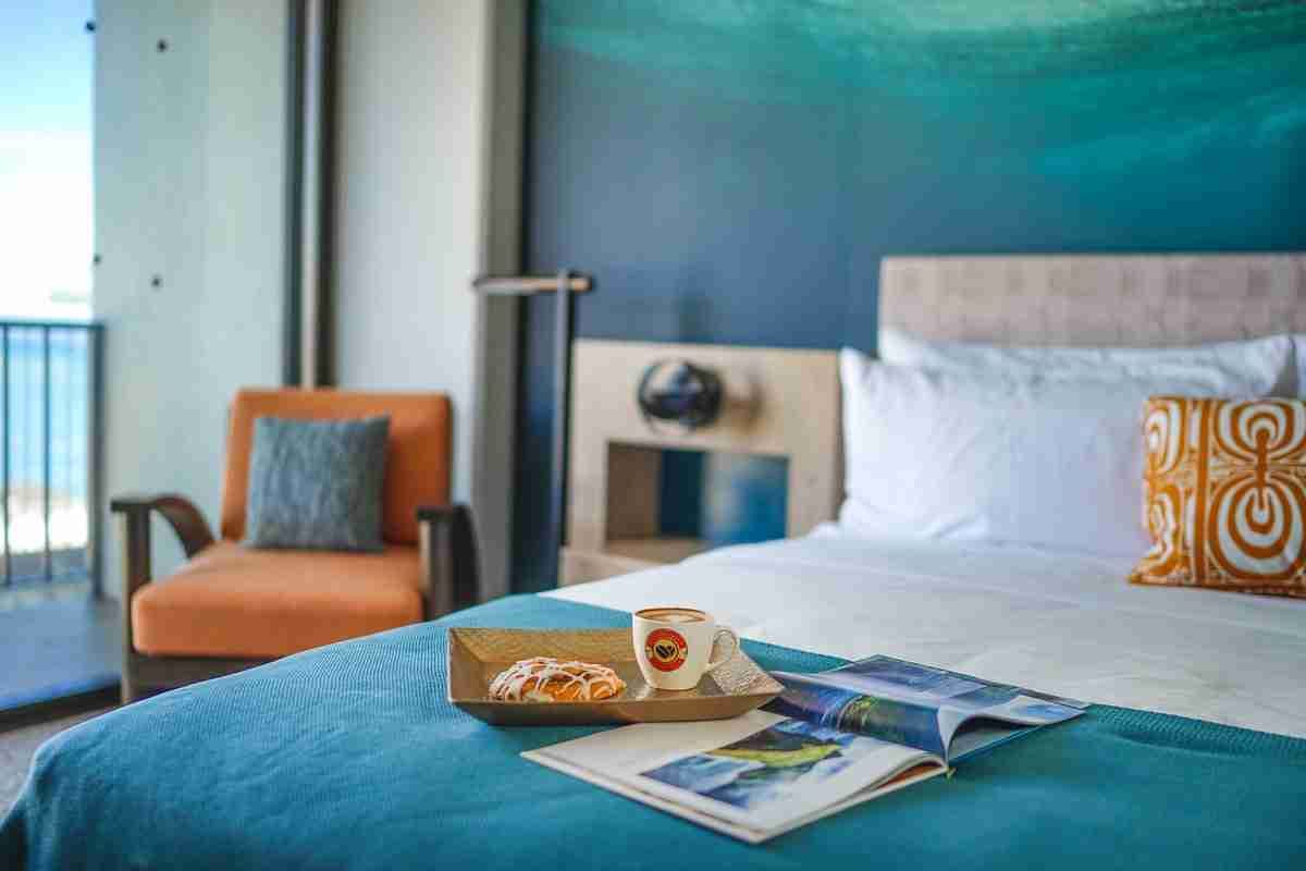 Modern guest room with ocean-inspired decor at the Outrigger Waikiki Beachcomber hotel.